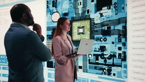 Engineering team analyzing semiconductor fabrication with laptop Video stock 330376227