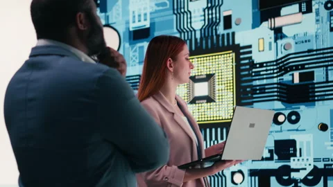 Engineering team analyzing semiconductor fabrication with laptop Stock Footage 330376681
