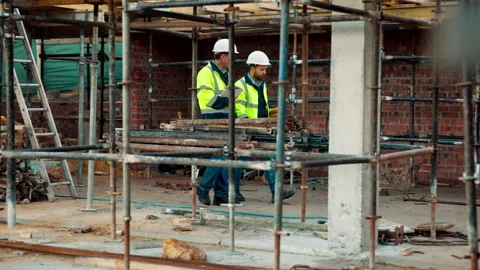 Engineering, team and walk on construction site with collaboration, tablet or Stock Footage 336198828
