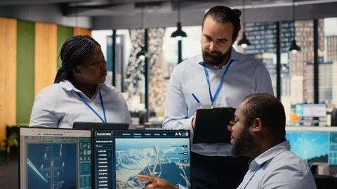 Engineering team brainstorming futuristic wind turbine concept Stock Photos