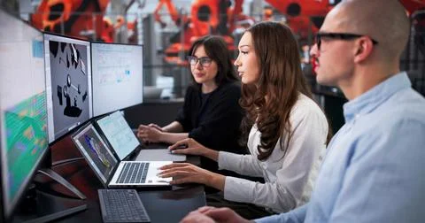 Engineering Team Creating 3D Model Of Car In Automotive Factory. Foto stock