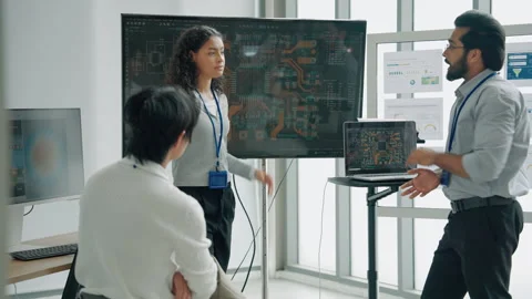 Engineering Team Discussing Circuit Board Design and Electronics Technology Stock Footage 348335758