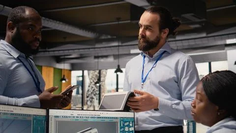Engineering team doing brainstorm, evaluating solar cell clean energy device Stock Photos
