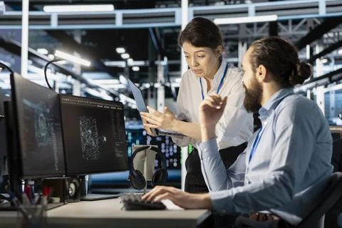 Engineering team doing brainstorming in server hub, using AI powered tech Stock Photos