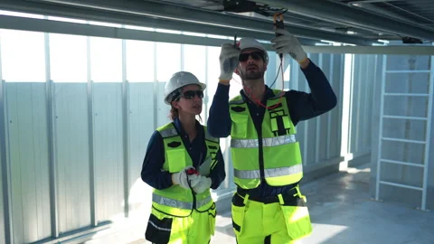 Engineering team measuring solar panel system performance Stock Footage 339647045