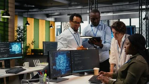 Engineering team in office using AI to optimize company systems Foto stock