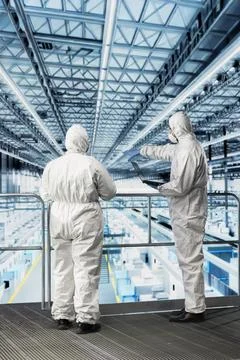 Engineering team optimizing microchip smart factory supply chain logistics Stock Photos