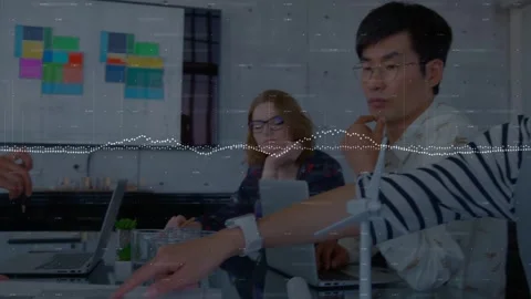 Engineering team reaching in, pointing energy plan on glass table, Stock Footage 331713499