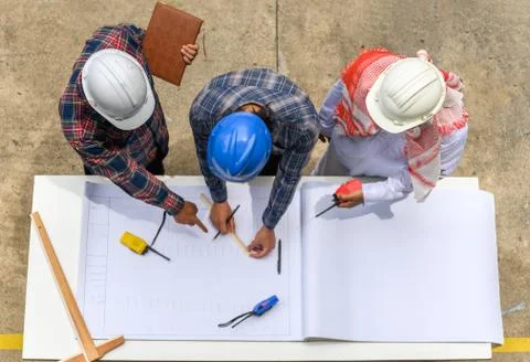 Engineering team in site manager field engineer and foreman looking at constr Stock Photos
