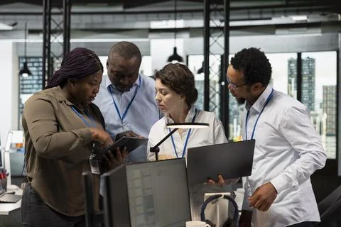 Engineering team using laptop in office to do software development 库存照片