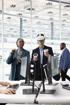 Engineering team using VR headset to do microchip yield enhancement Stock Photos