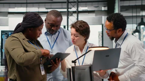 Engineering team working in AI startup training predictive models Stock Footage 322703198