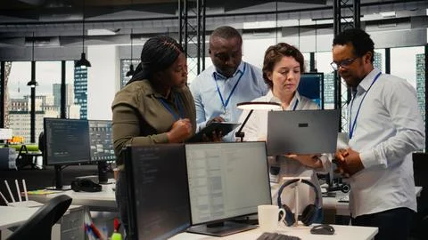 Engineering team working in AI startup training predictive models Stock Photos