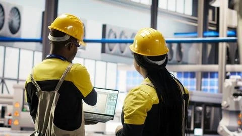 Engineering team working together to conduct inspections in industry 4.0 plant Stock Photos
