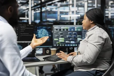 Engineering team working together in data center running AI tools Stock Photos