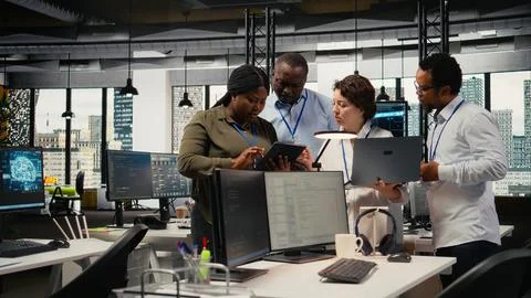 Engineering team working together in office, using AI specialized hardware Stock Photos