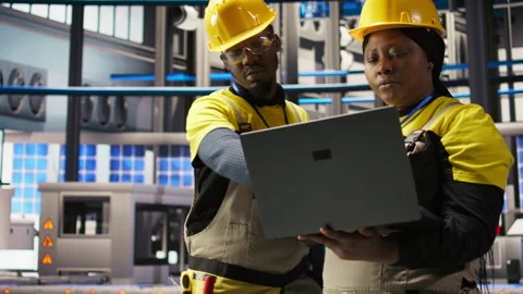 Engineering team working together, overseeing solar panel production lines Stock Footage 307365239