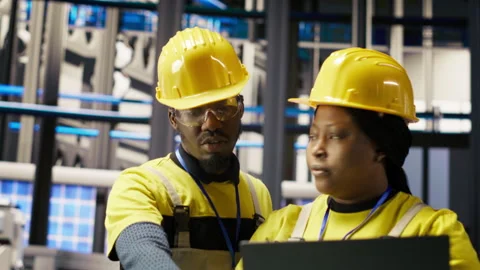Engineering team working together, overseeing solar panel production lines Stock Footage 307366226