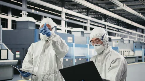 Engineering team working together in semiconductor production plant floor Stock Footage 333393833