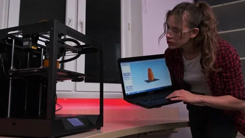 Engineering tech female student using 3D printer. Young woman work with three Stock Footage 154444373