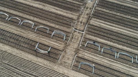 Engineering technicians install the skeleton of greenhouse and take aerial .. Stock Photos