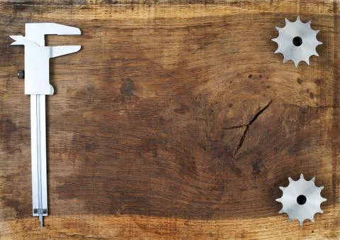 Engineering tools - gears and caliper on wooden table Stock Photos