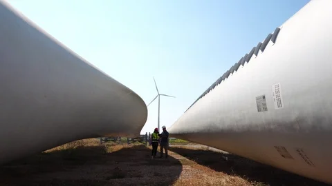 Engineering using Laptop at wind turbine  Stock Footage 121199976