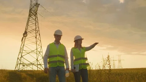 Engineering working on High-voltage tower, Check the information on the tablet Stock Footage 113395786