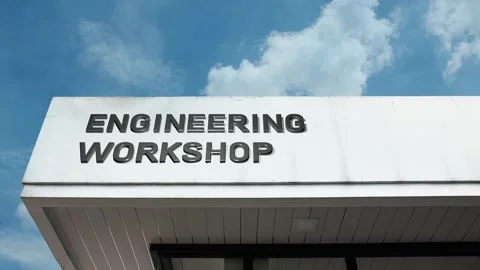 Engineering workshop word sign displayed on building with blue sky Stock Footage 318640276