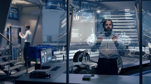 Engineers analyzing futuristic car chassis with digital screens Video stock 119231454