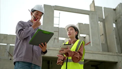 Engineers and architecture inspect and supervise the construction Stock Footage 309941243