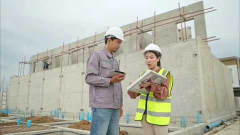 Engineers and architecture inspect and supervise the construction Stock Footage 309941544