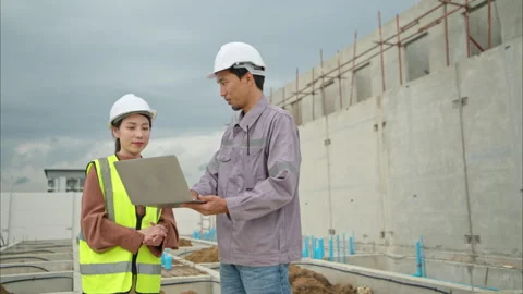 Engineers and architecture inspect and supervise the construction Stock Footage 309942325