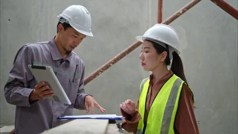 Engineers and architecture inspect and supervise the construction Stock Footage 309944475