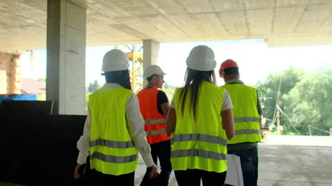 Engineers and builders perform walkaround of building Video stock 317615314