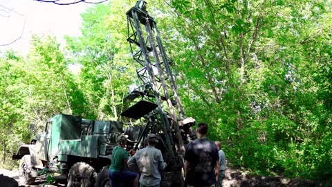 Engineers and drilling specialists operate the drilling equipment Stock Footage 338227198