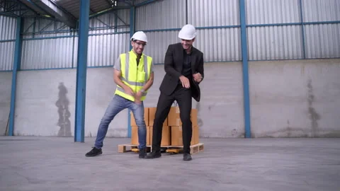 Engineers and INSPECTORS dance in the warehouse merrily. Stock Footage 139316107