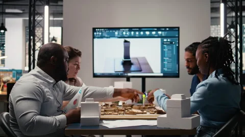 Engineers and real estate developers reviewing smart city design layout Stock Footage 316651426