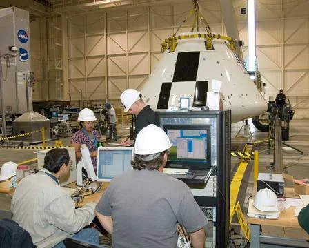 Engineers and technicians pore over data during moment-of-inertia testing ... Stock Photos