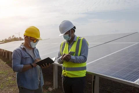Engineers and technicians work on planning to power solar panel renewable pow Stock Photos