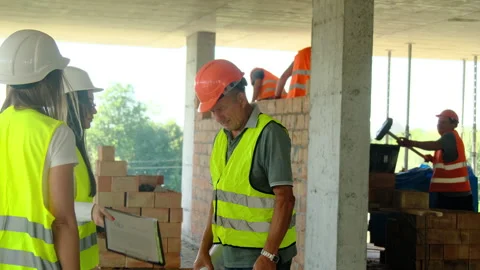 Engineers and worker discuss professional tasks during shift Stock Footage 317611466