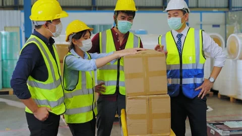 Engineers and workers stand together wearing masks to prevent the spread of the Stock Footage 159842554