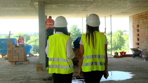 Engineers approach work area at spacious construction site Stock Footage 317610335