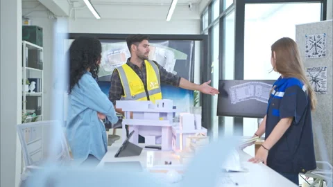 Engineers, architects, and designers collaborate to design a building Stock Footage 274532805