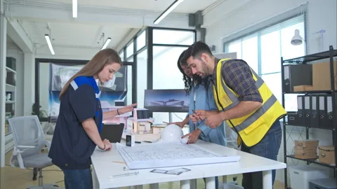 Engineers, architects, and designers collaborate to design a building Stock Footage 274538862