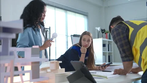 Engineers, architects, and designers collaborate to design a building Stock Footage 274542575
