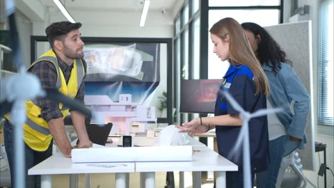 Engineers, architects, and designers collaborate to design a building Stock Footage 274689772