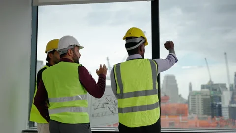 Engineers, architects and foremen are having a meeting to plan Stock Footage 214454194