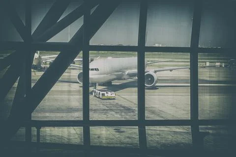 Engineers are checking the front wheels of the aircraft. Stock Photos