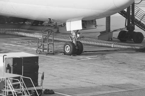 Engineers are checking the front wheels of the aircraft. Stock Photos